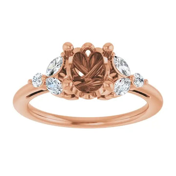 Rose gold engagement ring setting with oval center stone and round accent stones on sides.