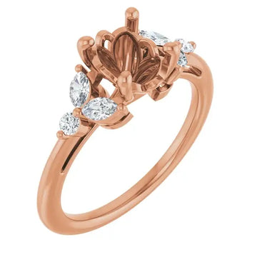 Rose gold engagement ring setting with ornate floral center design and oval stone accents on band.