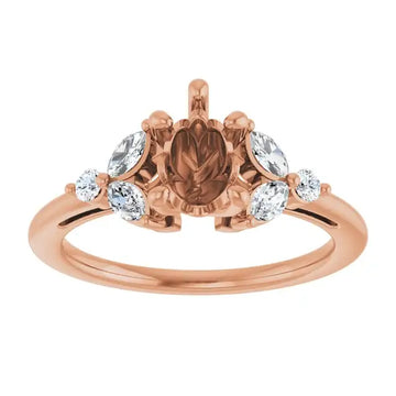 Rose gold ring setting with pear-shaped center stone and oval accent stones on either side.
