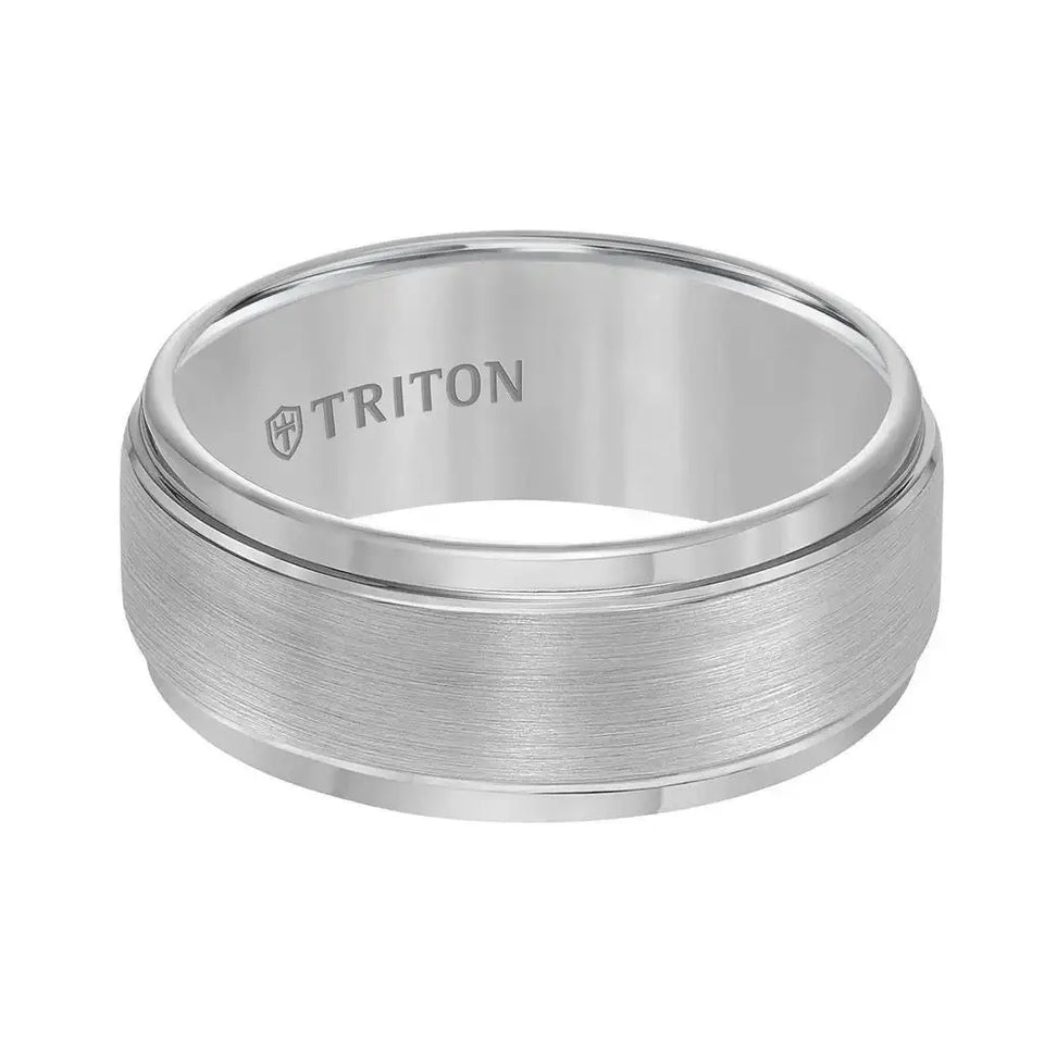 Flat lay of the same gray brushed tungsten carbide ring showing polished step edges and TRITON engraving