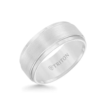 Angled view of the EDWARD 9mm white tungsten carbide ring with raised brushed center and polished step edges, Triton logo inside