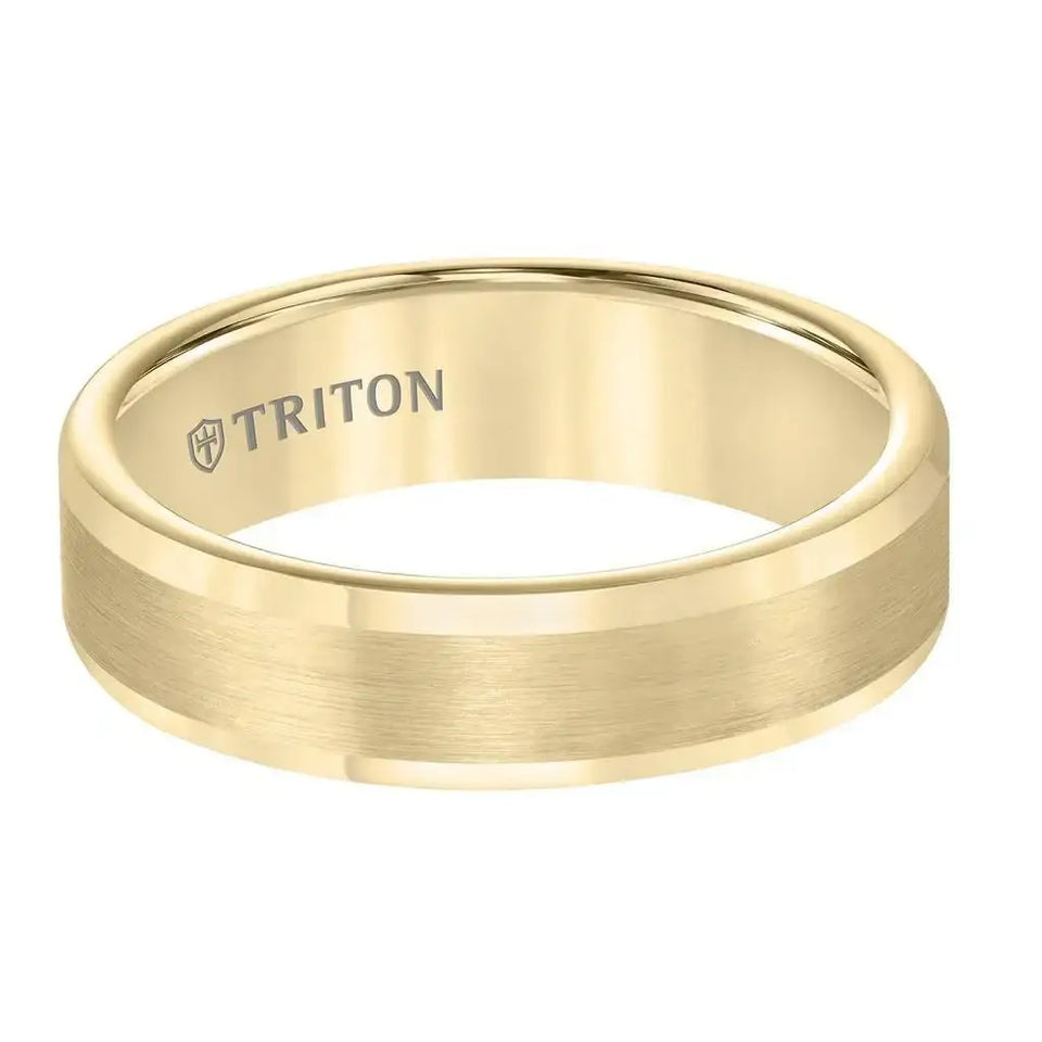 Close-up of 6mm flat yellow gold-tone tungsten carbide ring showing satin center strip and polished edges with TRITON logo inside