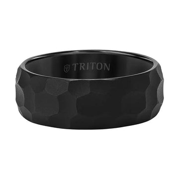 Lifestyle image of a person wearing the black hammered tungsten carbide wedding band on the ring finger