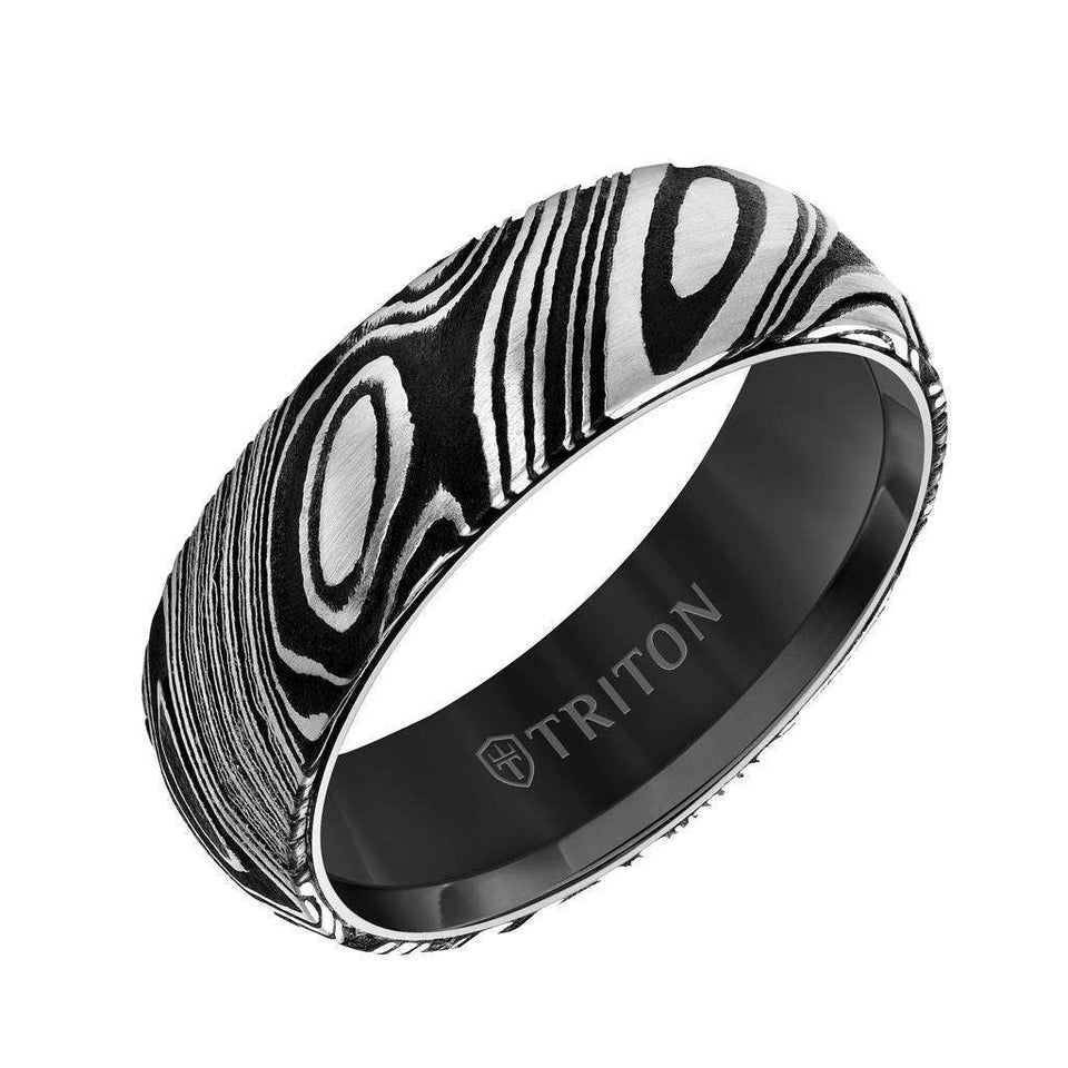 Angled view of a 7mm black tungsten carbide ring with Damascus steel pattern and TRITON branding inside