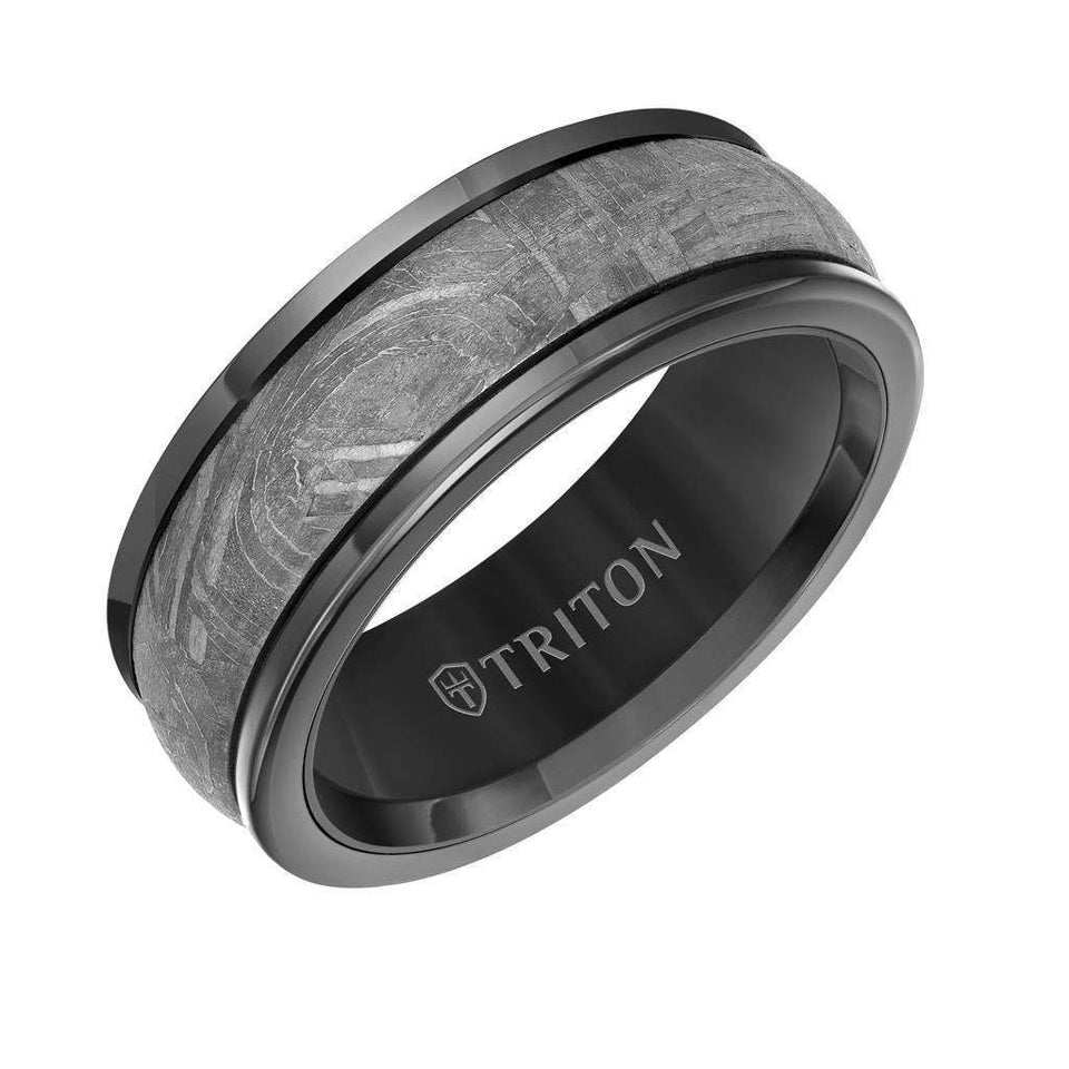Angled view of an 8mm black tungsten carbide wedding band with rounded edges and a gray meteorite inlay, interior engraved with TRITON logo