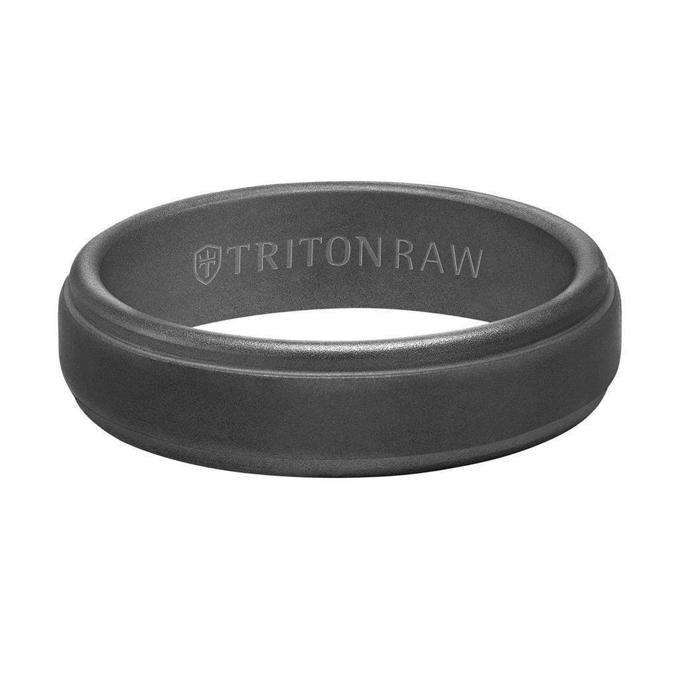 Flat lay of the same 6mm sandblasted step-edge ring showing the TRITON RAW interior engraving