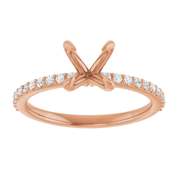 Rose gold engagement ring setting with diamond accents along the band and empty prongs at top for round stone.