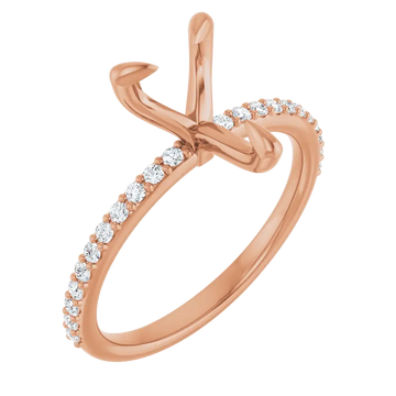 Rose gold ring setting with pear-shaped stone prongs and round diamond accents along the band.