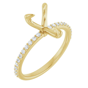 Gold engagement ring setting with pear-shaped stone holder and round diamond accents along the band.