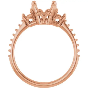 Rose gold engagement ring setting with ornate scrollwork crown and empty oval stone center.