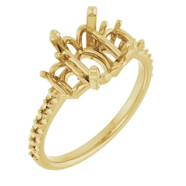 Gold engagement ring setting with oval stone holder and textured band detailing.