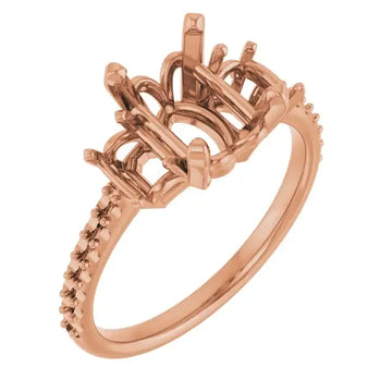 Rose gold engagement ring setting with ornate oval stone holder and decorative shoulder details.