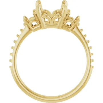 Yellow gold engagement ring setting with ornate crown-style head and studded band, designed for emerald stone placement.