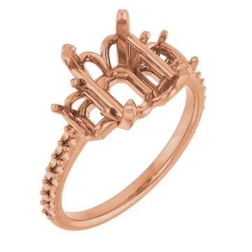 Rose gold engagement ring setting with ornate open gallery and diamond-accented band, sized for emerald stones.