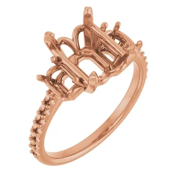 Rose gold engagement ring setting with ornate open gallery and diamond-accented band, sized for emerald stones.