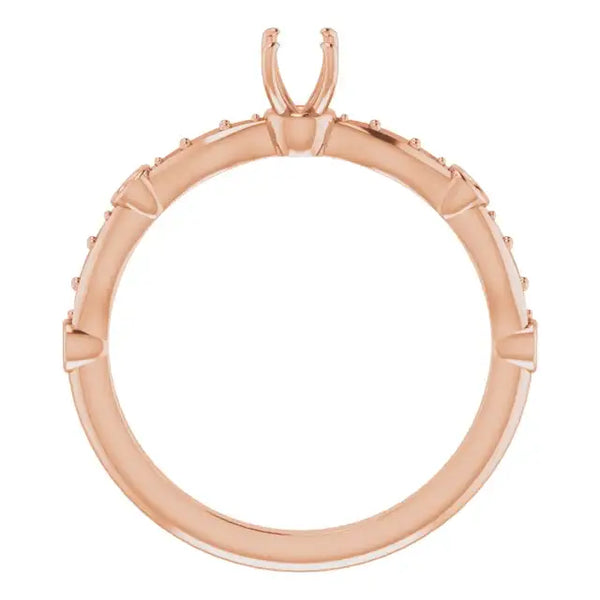 Rose gold engagement ring setting with accent stones and prongs for center stone, shown from top view.