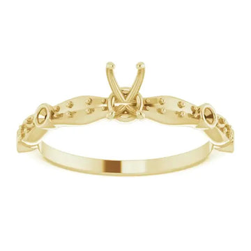 Gold engagement ring setting with X-shaped center prong and beaded detailing on shoulders, designed for emerald-cut stones.