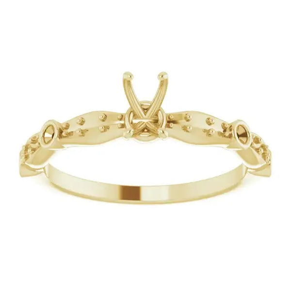 Gold engagement ring setting with X-shaped center prong and beaded detailing on shoulders, designed for emerald-cut stones.
