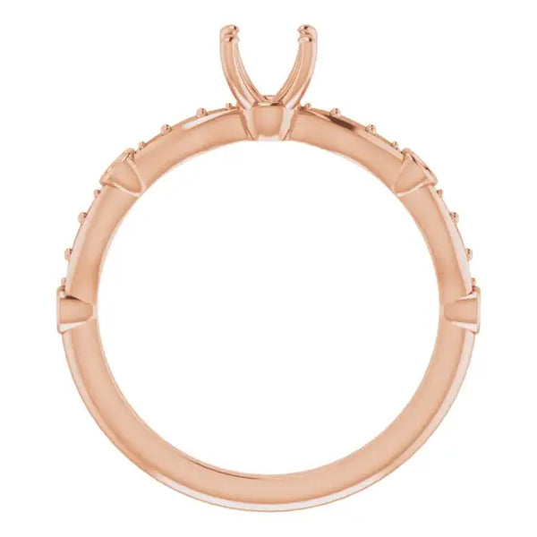 Rose gold engagement ring setting with square stone prongs and small diamond accents along the band.