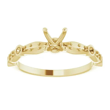 Gold engagement ring setting with X-shaped center and decorative beaded shoulders for square stones.