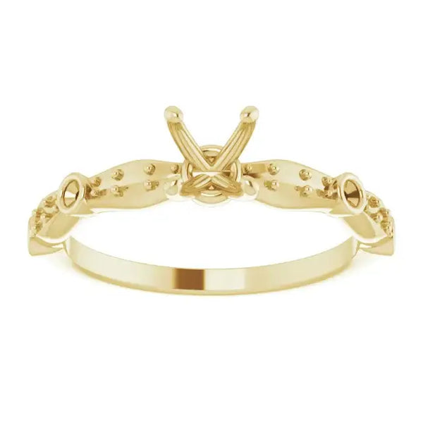 Gold engagement ring setting with X-shaped center and decorative beaded shoulders for square stones.