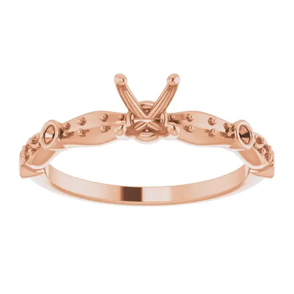 Rose gold engagement ring setting with decorative prongs and beaded detailing for square stones.