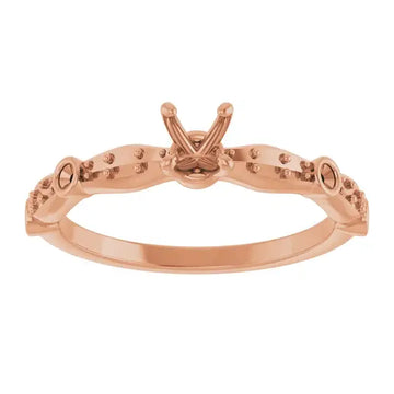 Rose gold engagement ring setting with V-shaped prongs and decorative beadwork along the band.