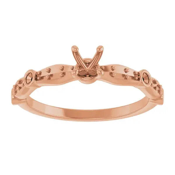 Rose gold engagement ring setting with V-shaped prongs and decorative beadwork along the band.