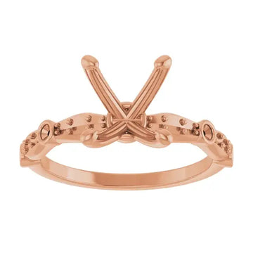 Rose gold engagement ring setting with oval stone holder and decorative side accents.
