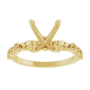 Yellow gold engagement ring setting with crossed prongs and beaded band, designed for oval stones.