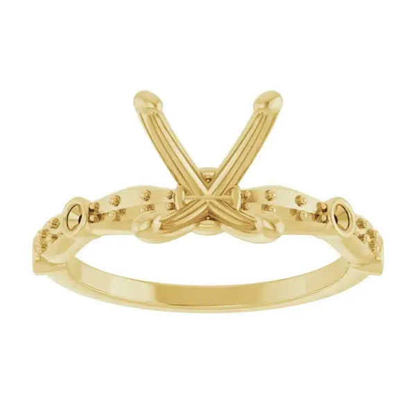 Yellow gold engagement ring setting with crossed prongs and beaded band, designed for oval stones.