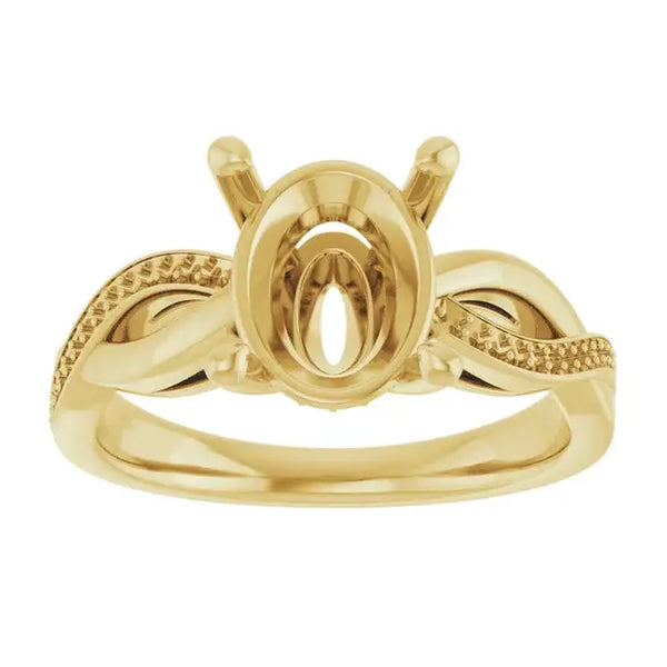 Yellow gold engagement ring setting with oval stone cup, textured side bands, and decorative shoulders.
