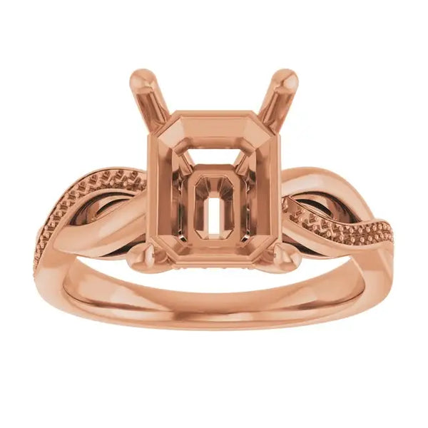 Rose gold engagement ring setting with emerald-cut stone holder and textured twisted band sides.