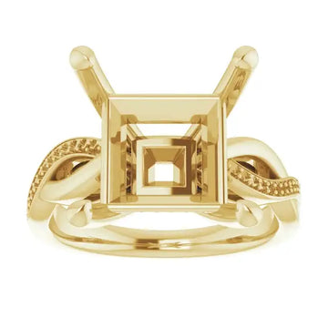 Gold engagement ring setting with square stone holder and twisted band details on sides.