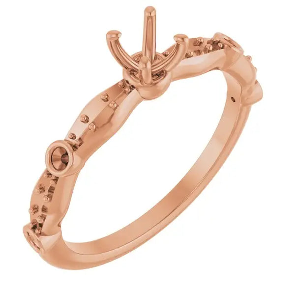 Rose gold engagement ring setting with ornate band and decorative prong head for round stone.