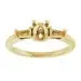Gold engagement ring setting with oval stone placeholder and decorative side stones.