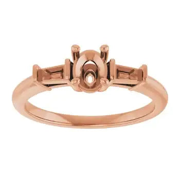 Rose gold engagement ring setting with oval stone holder and side accents on polished band.