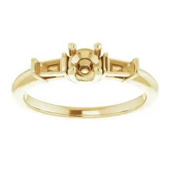 Gold engagement ring setting with round stone center cup and rectangular side stone accents.