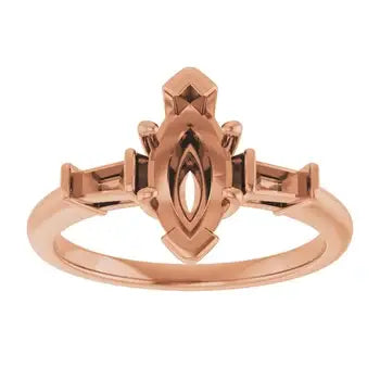 Rose gold engagement ring setting with marquise-shaped stone center and decorative geometric band design.