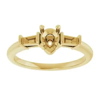 Gold-toned engagement ring setting with pear-shaped stone center and rectangular side stone supports.