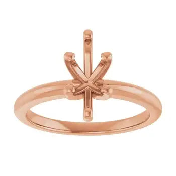 Rose gold solitaire engagement ring setting with four-prong marquise stone holder, displayed on plain background.