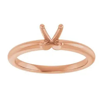Rose gold solitaire engagement ring setting with V-shaped prongs for round stones.
