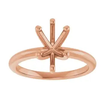 Rose gold solitaire engagement ring setting with pear-shaped stone holder and decorative prong framework.