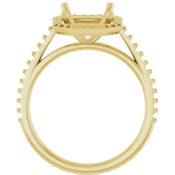 Gold-toned engagement ring setting with four-prong halo and pavé-set stones on band, viewed from side.