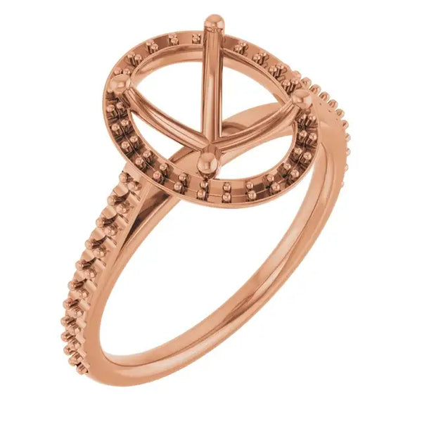 Rose gold ring with four-prong oval halo setting and pavé-set stones along the band.
