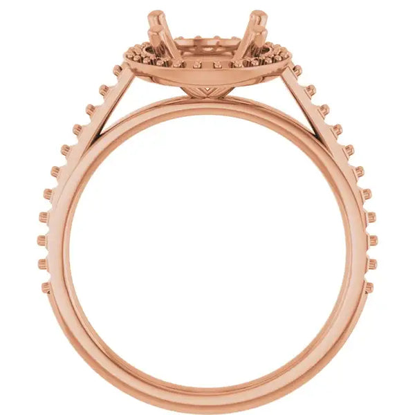 Rose gold engagement ring setting with halo and pavé diamond accents, four-prong oval stone mount, shown from side view.