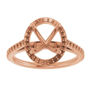 Rose gold engagement ring setting with oval halo, four prongs, and pavé-set band for center stone.