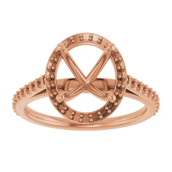 Rose gold engagement ring setting with oval halo, four prongs, and pavé-set band for center stone.