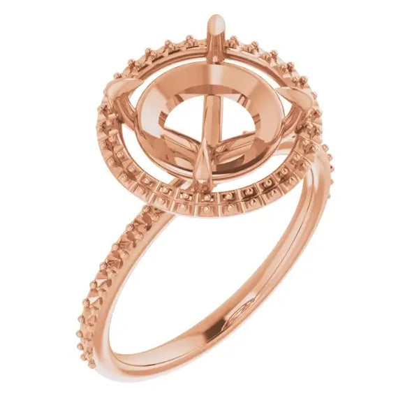 Rose gold halo engagement ring setting with textured band and empty round stone center.