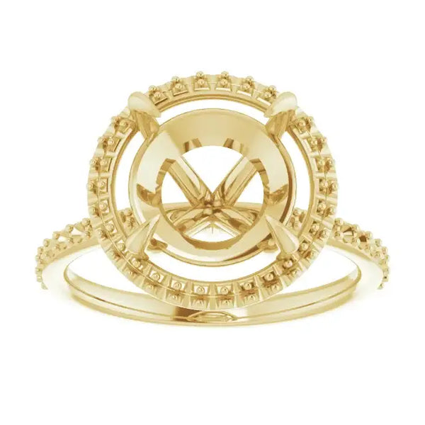 Yellow gold halo engagement ring setting with round center stone mounting and accent stones around the band.